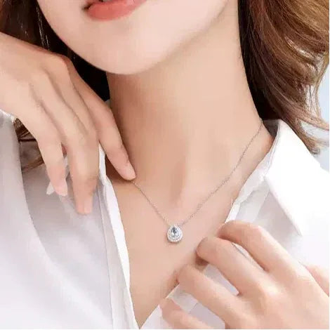 Pear-Cut Aquamarine Halo Pendant Necklace worn at the neckline from a second angle