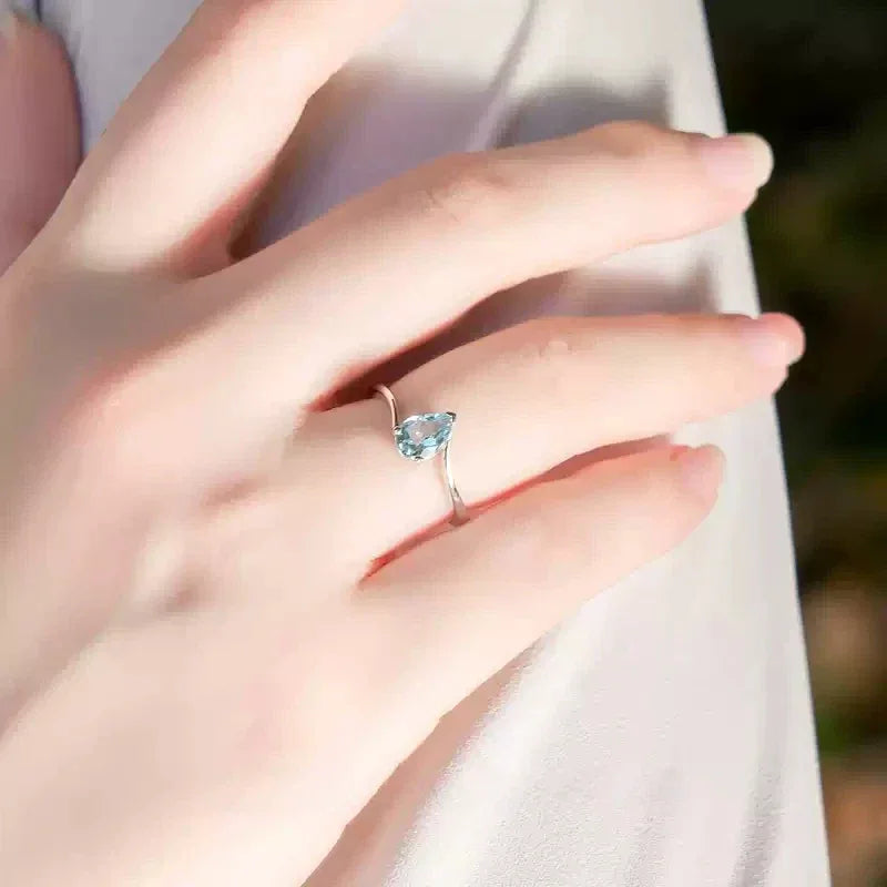 Pear-Cut Aquamarine Open Ring worn on the hand in a close-up