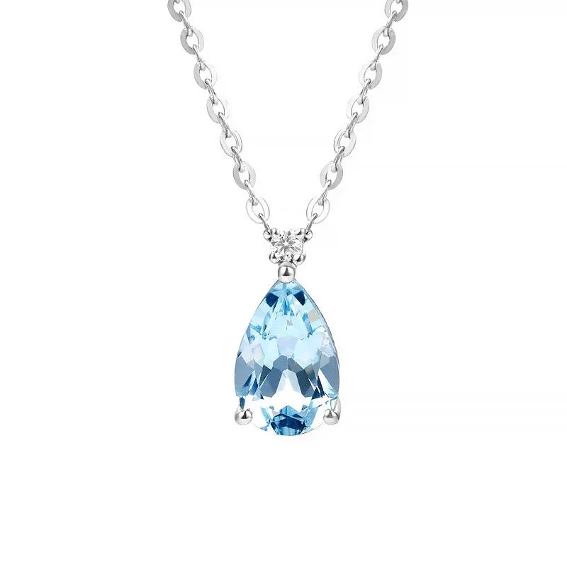 Pear-Cut Aquamarine Pendant Necklace pendant and chain detail on a light background