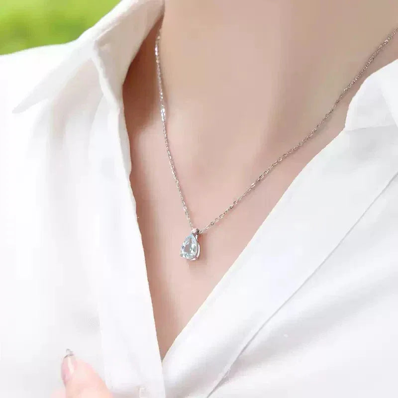 Pear-Cut Aquamarine Pendant Necklace worn at the neckline in a close-up