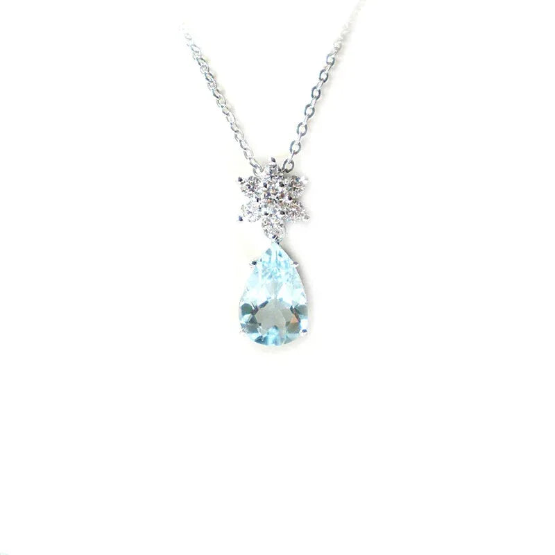 Pear-Cut Aquamarine Snowflake Drop Necklace pendant and chain detail on a light background