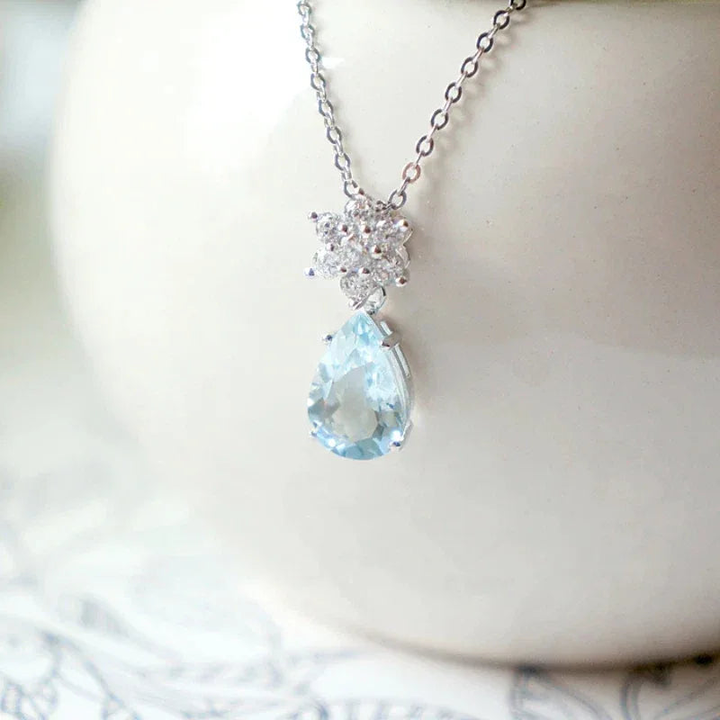 Pear-Cut Aquamarine Snowflake Drop Necklace styled neckline view showing pendant scale