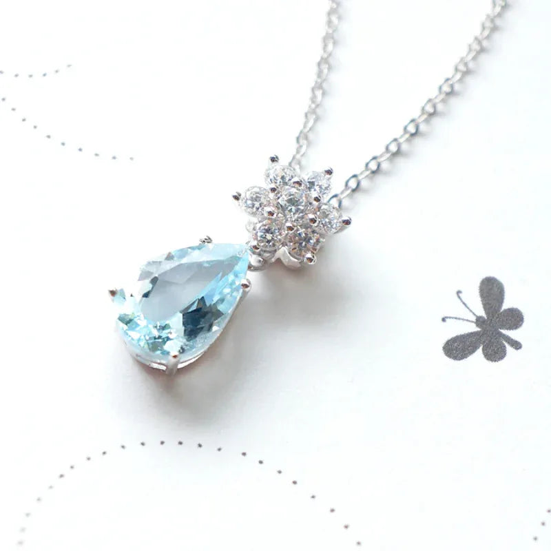 Pear-Cut Aquamarine Snowflake Drop Necklace worn at the neckline from a second angle
