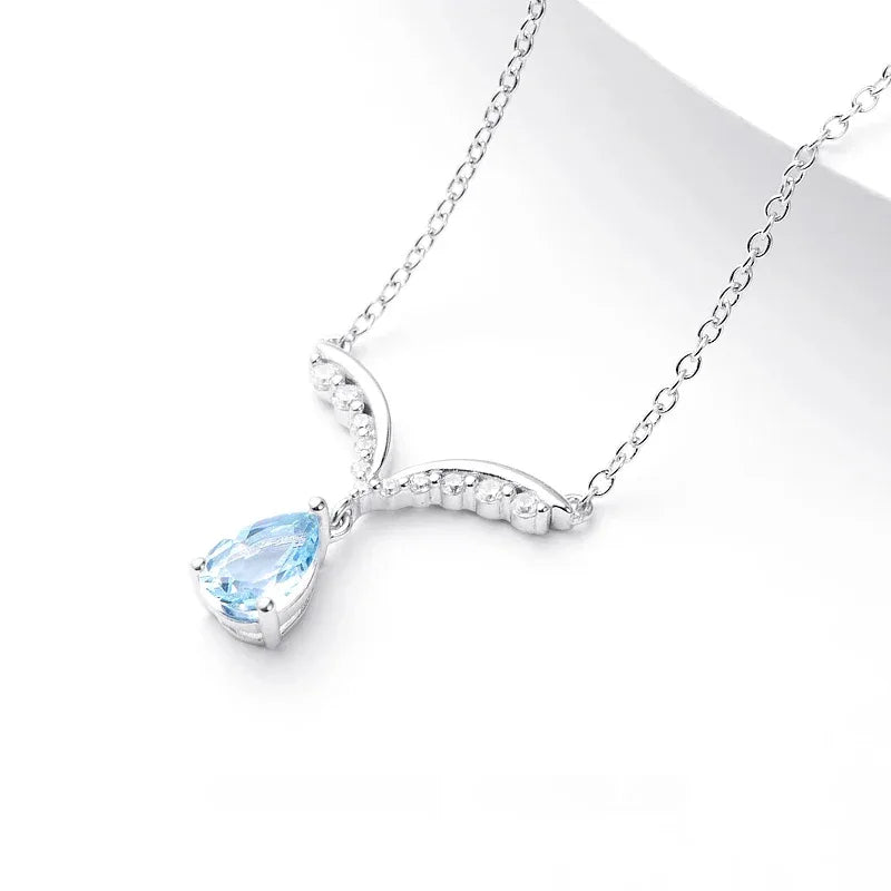 Pear-Cut Aquamarine Wing Pendant Necklace pendant and chain detail on a light background