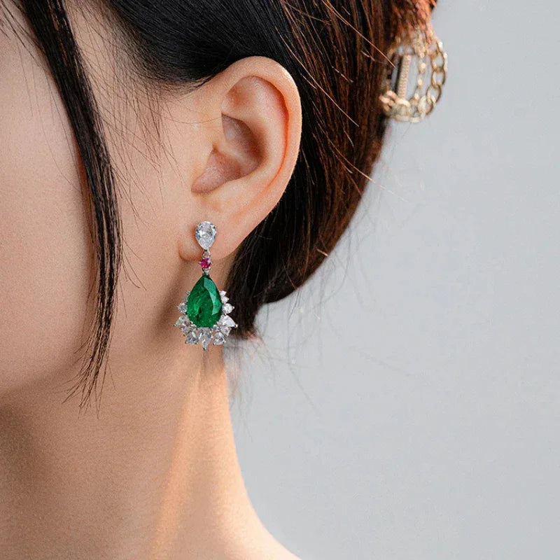 Pear-Cut Emerald and Pink Accent Drop Earrings worn on the ear from a second angle