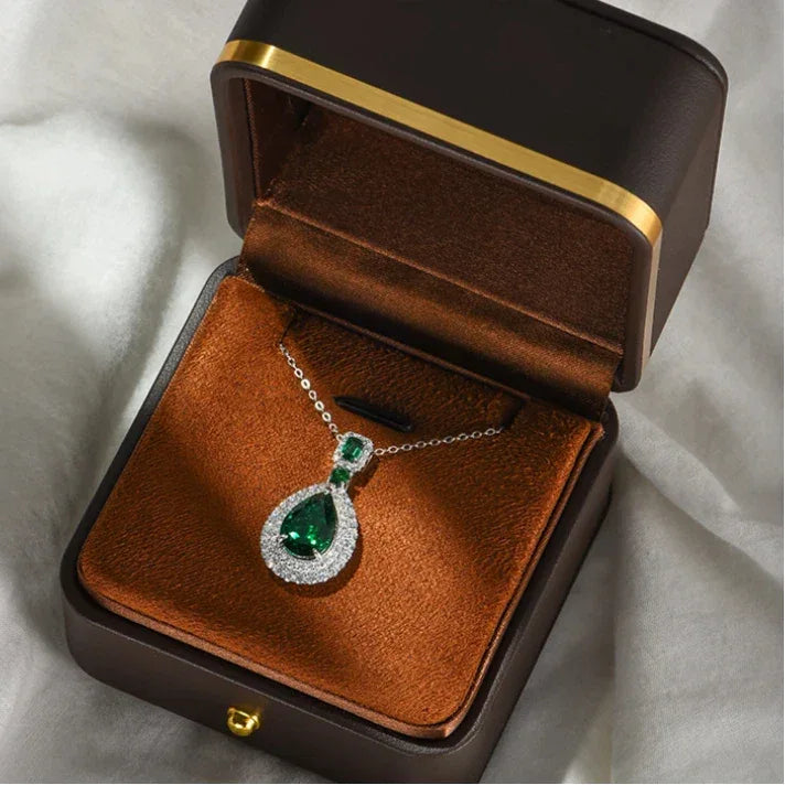 Pear-Cut Emerald Double-Halo Pendant Necklace worn at the neckline from a second angle