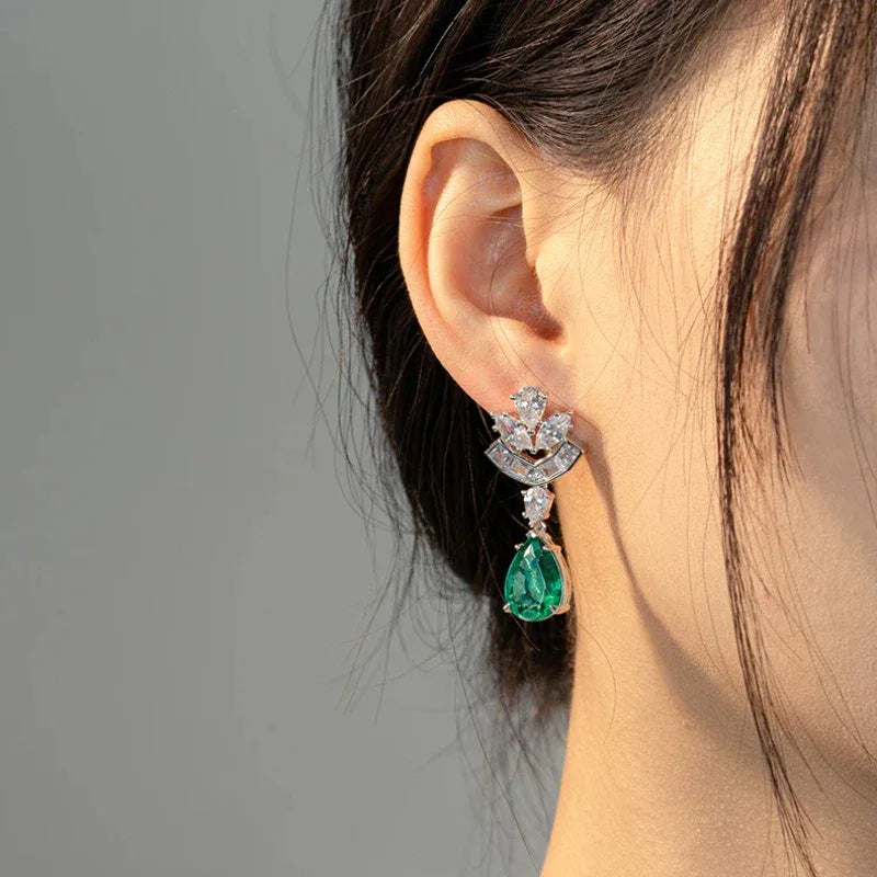 Pear-Cut Emerald Floral Drop Earrings styled ear view showing scale