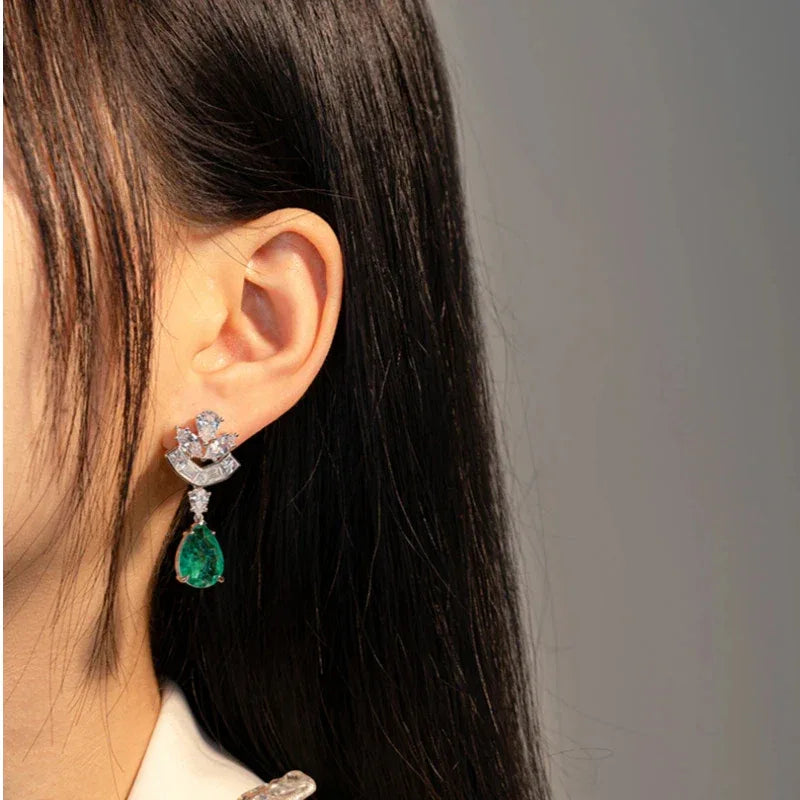 Pear-Cut Emerald Floral Drop Earrings worn on the ear from a second angle