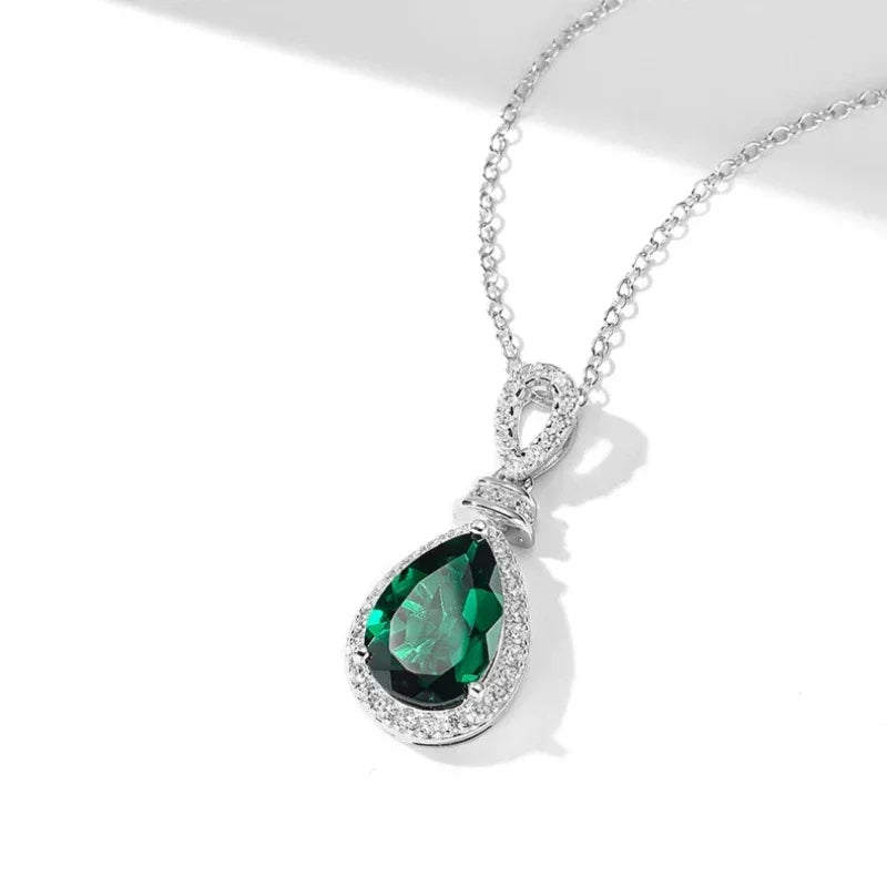 Pear-Cut Emerald Halo Pendant Necklace pendant and chain detail on white