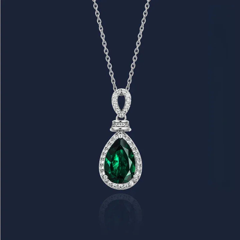 Pear-Cut Emerald Halo Pendant Necklace pendant view on a dark background