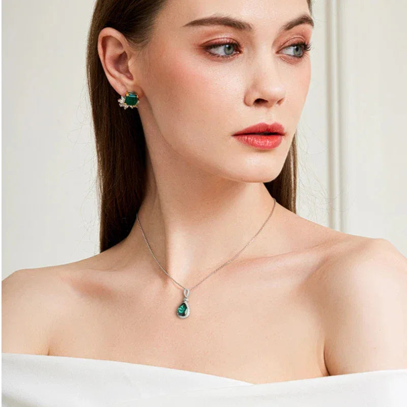 Pear-Cut Emerald Halo Pendant Necklace worn at the neckline from a second angle