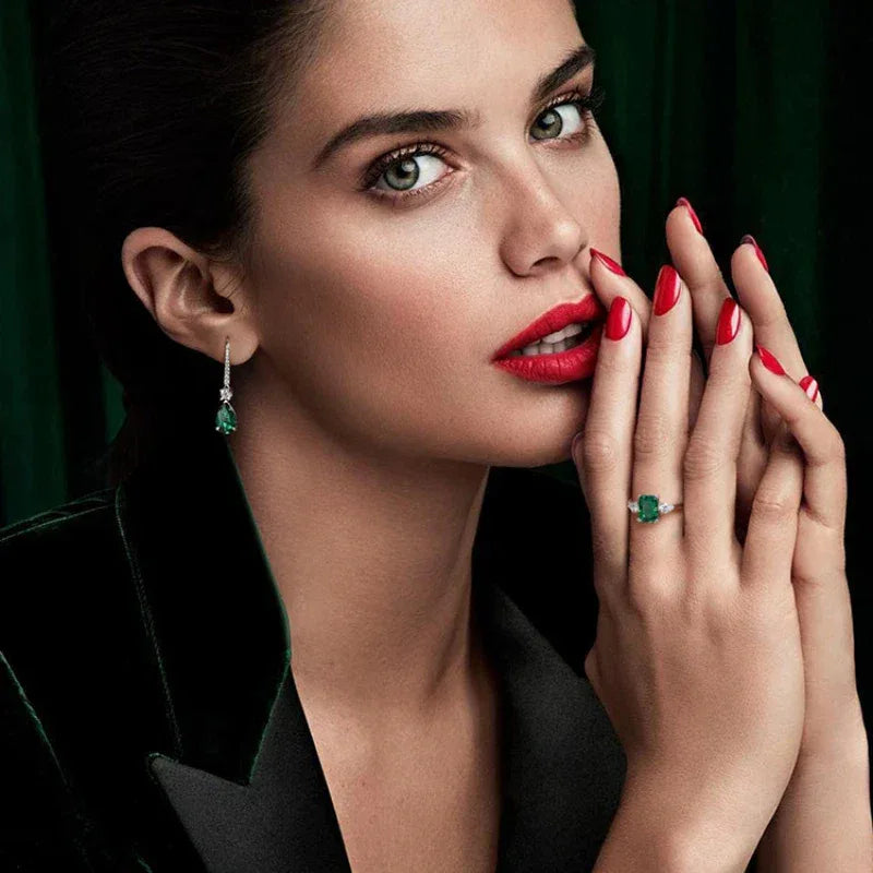 Pear-Cut Emerald Long Drop Earrings styled ear view showing scale