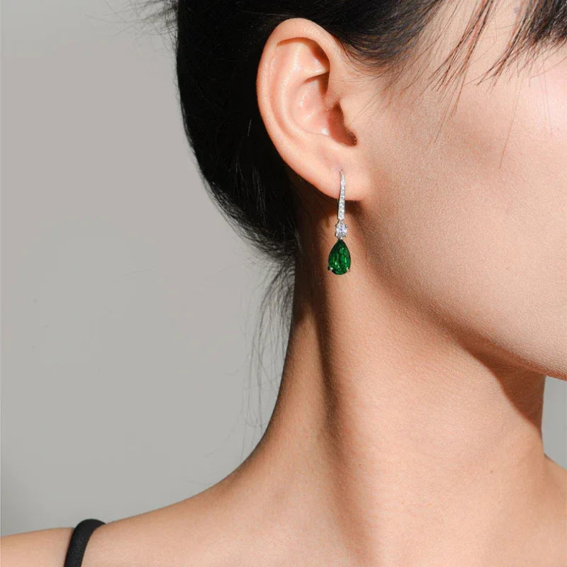 Pear-Cut Emerald Long Drop Earrings worn on the ear from a second angle