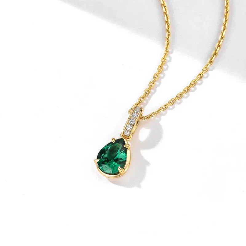 Pear-Cut Emerald Pendant Necklace pendant and chain detail on white