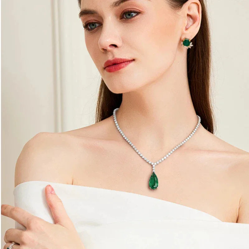 Pear-Cut Emerald Tennis Necklace worn at the neckline in a close-up