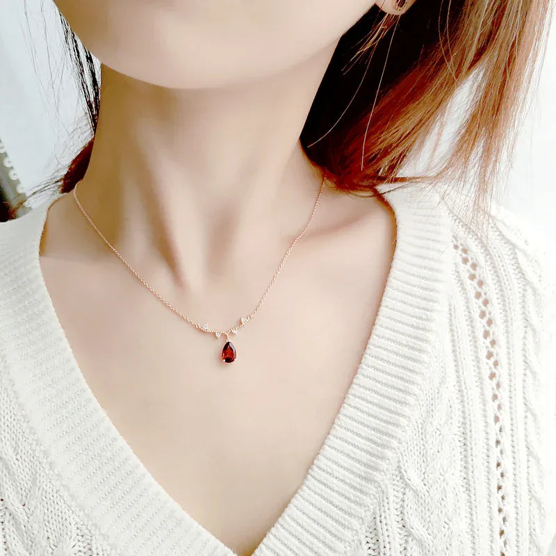 Pear-Cut Garnet Drop Necklace worn at the neckline from a second angle