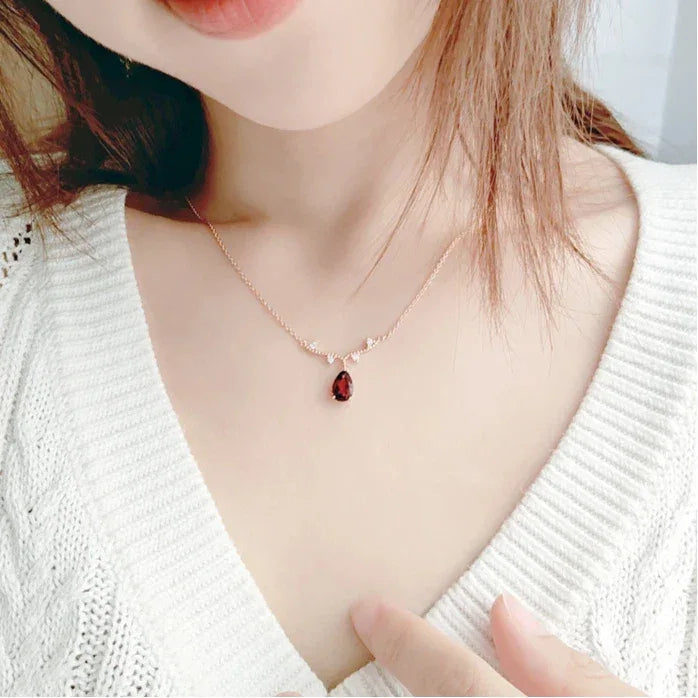 Pear-Cut Garnet Drop Necklace worn at the neckline in a close-up