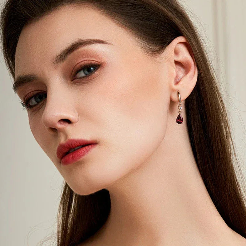 Pear-Cut Garnet Hook Drop Earrings worn on the hand from a second angle