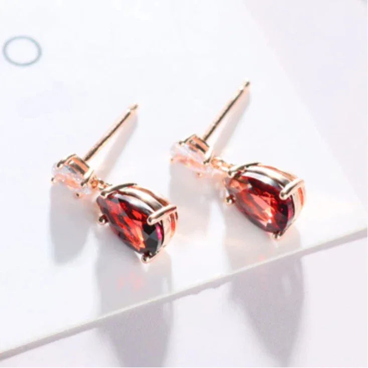 Pear-Cut Garnet Pavé Drop Earrings side view held between the fingers