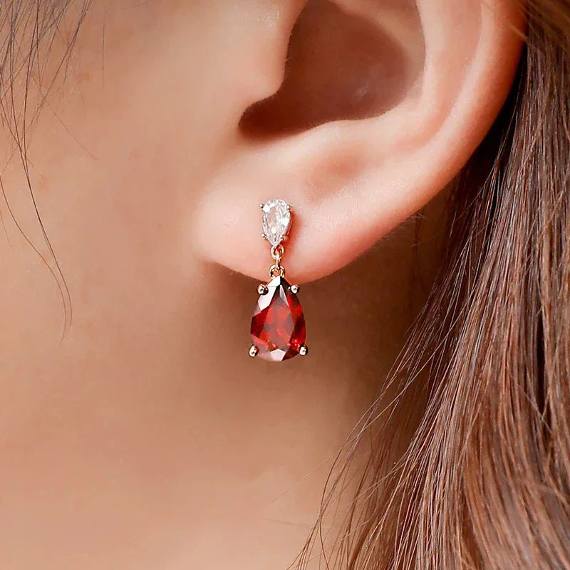 Pear-Cut Garnet Pavé Drop Earrings worn on the hand in a close-up