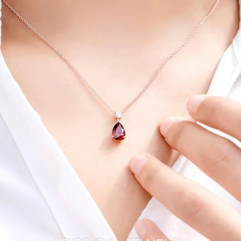 Pear-Cut Garnet Pendant Necklace worn at the neckline in a close-up