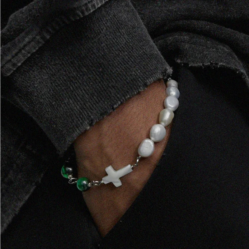 Pearl and Green Tiger Eye Cross Bracelet — wrist-worn close-up under a dark sleeve