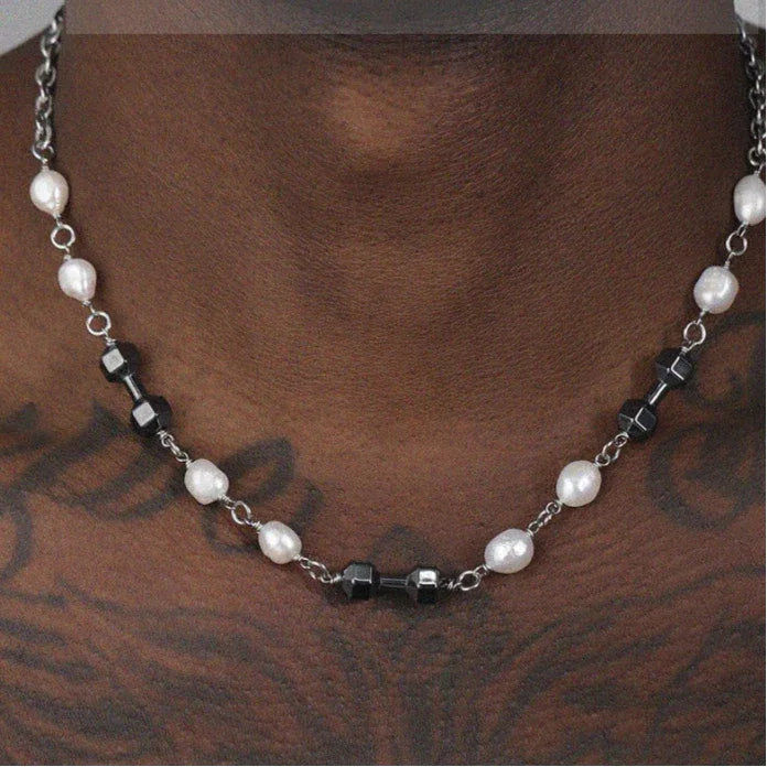 Pearl and Obsidian Beaded Necklace — chest-worn view over tattooed skin