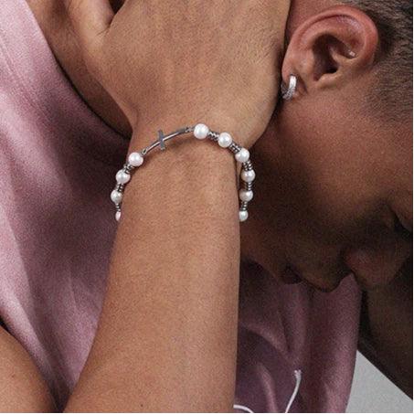 Adjustable Pearl and Titanium Steel Cross Bracelet — side wrist-worn portrait beside the model's face