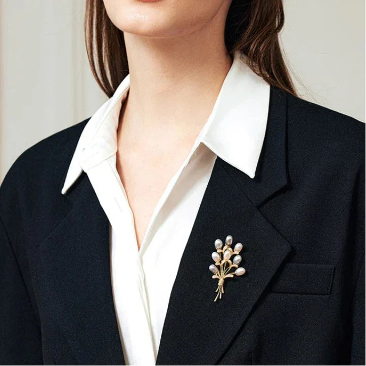 Two-Tone Pearl Bouquet Brooch — close blazer-worn view showing scale