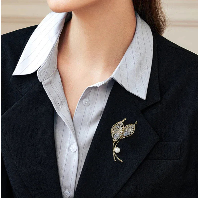 Pearl Calla Lily Brooch — close blazer-worn view showing the two lily heads