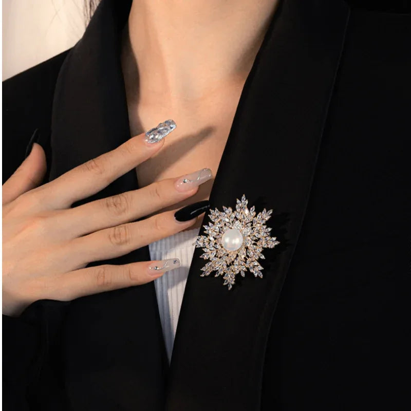 Pearl Snowflake Brooch — close blazer-worn view beside a model's hand