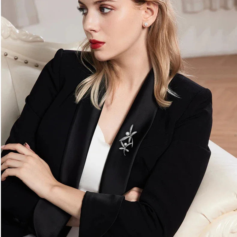 Pearl and Cubic Zirconia Dragonfly Brooch — seated model wearing the brooch on a black blazer