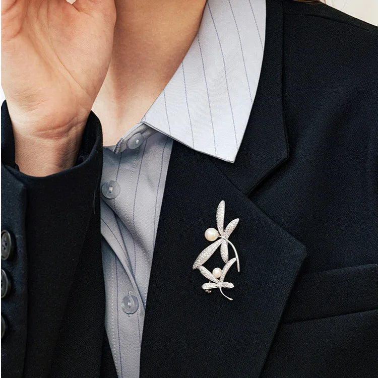 Pearl and Cubic Zirconia Dragonfly Brooch — brooch pinned on a black blazer in a close worn view
