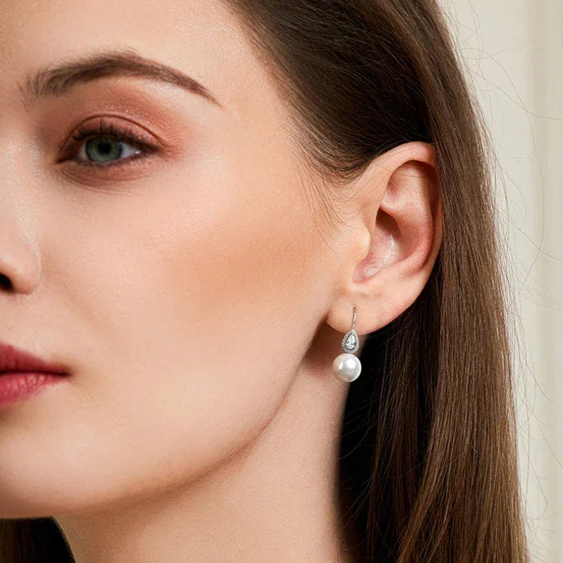 Pearl Teardrop Halo Earrings — right-ear worn portrait showing both earrings