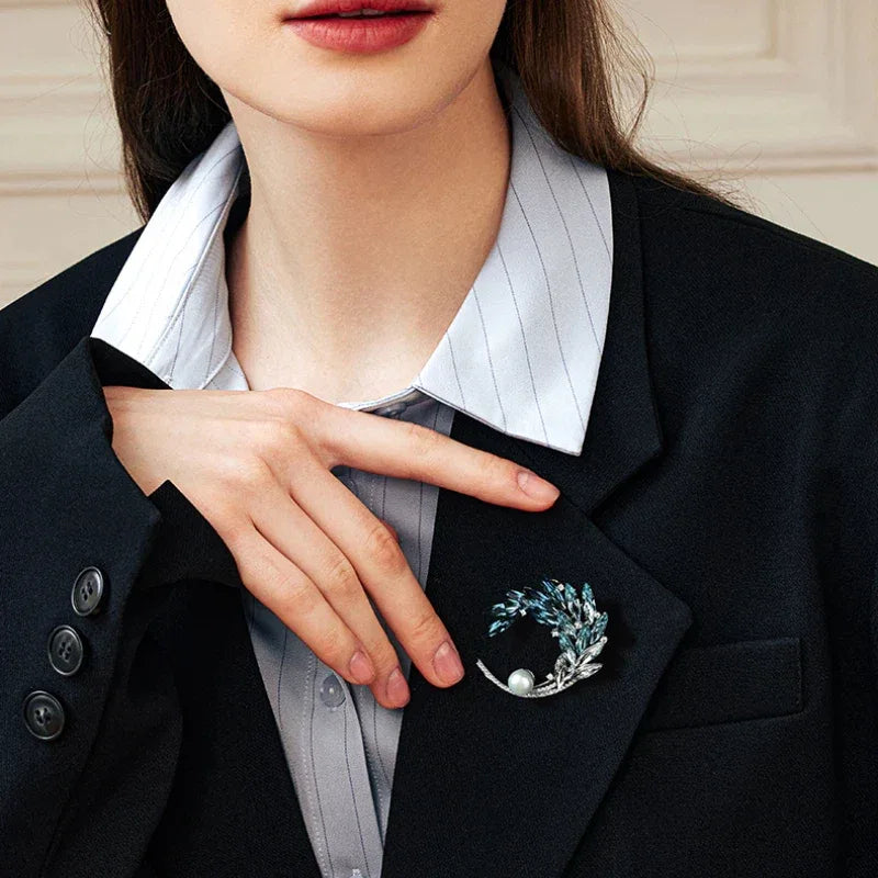 Gradient Blue Wheat Wreath Pearl Brooch — waist-up model portrait beside the brooch