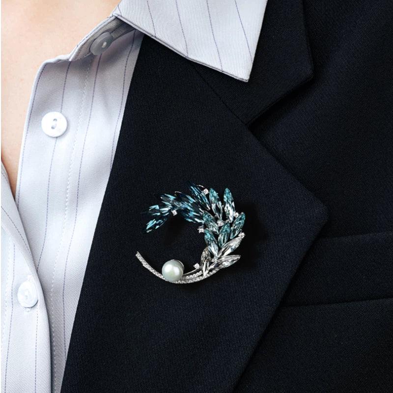 Gradient Blue Wheat Wreath Pearl Brooch — close blazer-worn view showing the crescent orientation