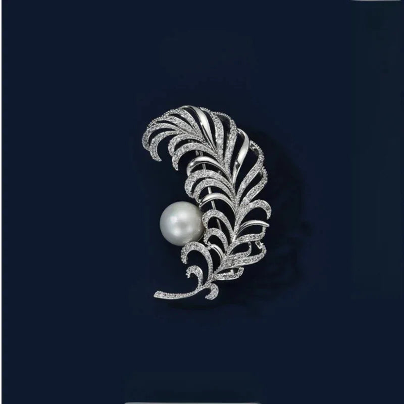 Pearl Feather Brooch — front product view on a dark background
