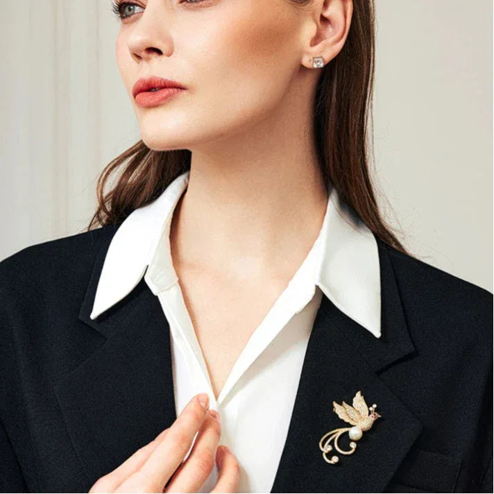 Pearl Phoenix Brooch — waist-up model portrait with the brooch on a dark blazer