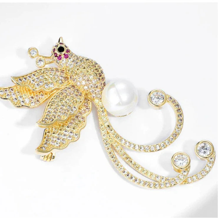 Pearl Phoenix Brooch — angled close-up showing the pearl body and curling tail