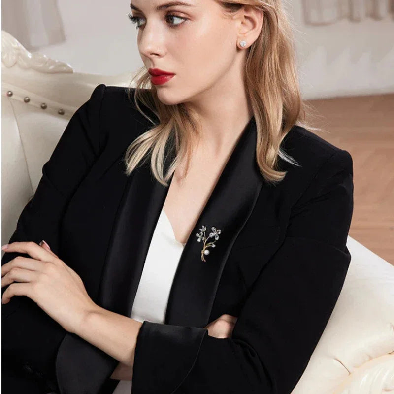 Pearl Floral Branch Brooch — seated model wearing the brooch