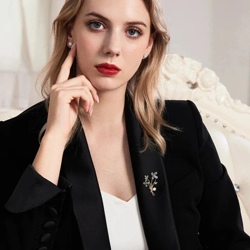Pearl Floral Branch Brooch — model portrait with the brooch pinned on a dark blazer