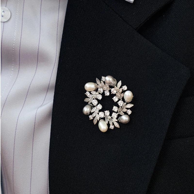 Pearl and Cubic Zirconia Olive Leaf Wreath Brooch — close blazer-worn view showing scale