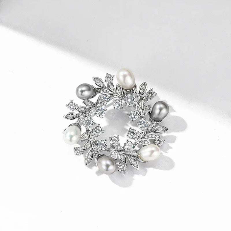 Pearl and Cubic Zirconia Olive Leaf Wreath Brooch — angled product view on white