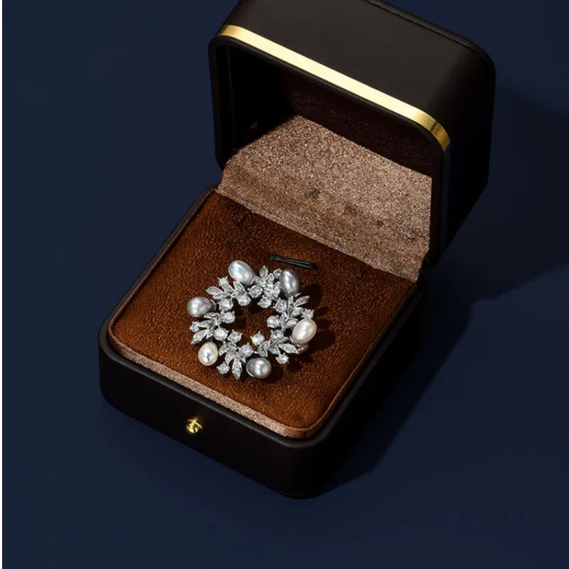 Pearl and Cubic Zirconia Olive Leaf Wreath Brooch — brooch displayed inside a jewelry gift box