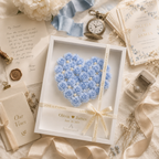 Close-up detail of handcrafted blue paper rose heart shadow box showing individually rolled dusty blue roses ivory pearl