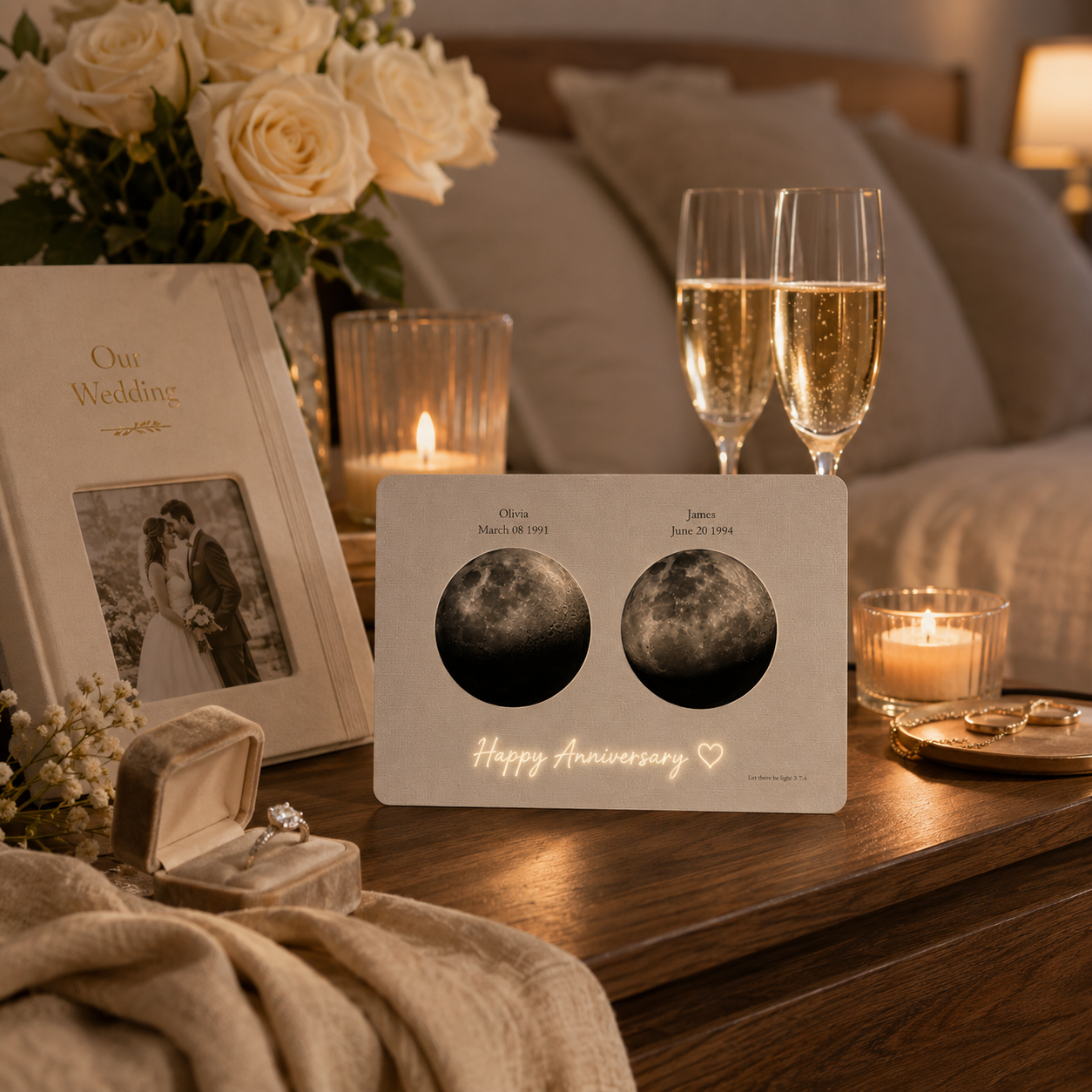 Personalized double moon phase hidden message film card displayed on a walnut bedside table beside Our Wedding album