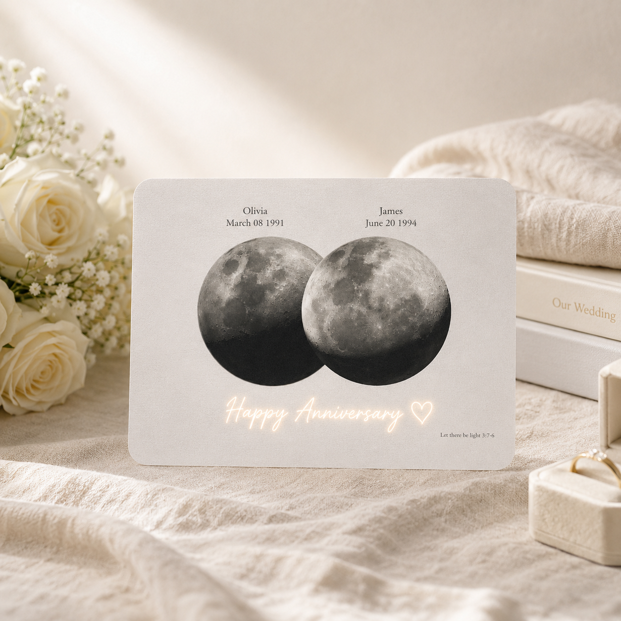 Personalized overlapping double moon phase hidden message film card displayed on cream linen surface beside white roses