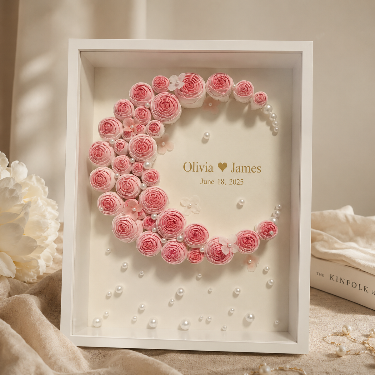 Personalized paper rose monogram shadow box displaying crescent moon shape formed from hand-rolled blush pink roses with
