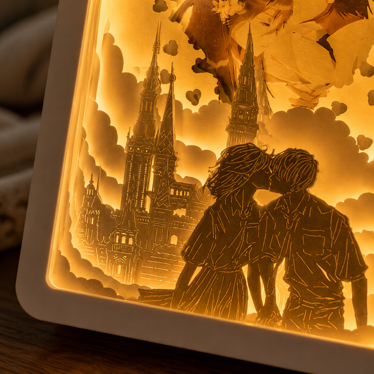 Lifestyle flat lay of personalized paper cut light box surrounded by wedding invitation dried flowers pocket watch ring