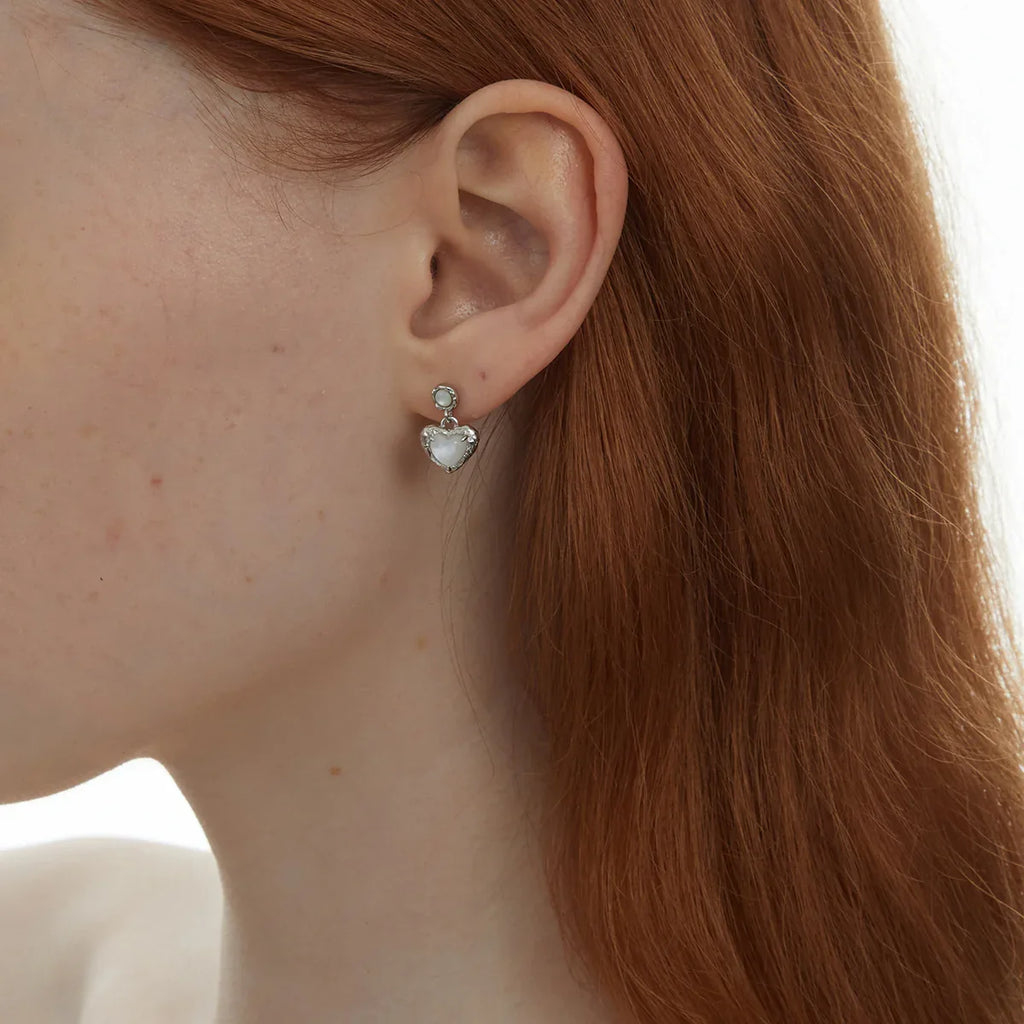 Pearl Heart Drop Earrings with Ornate Frame — right-ear worn close-up showing the two-part drop construction